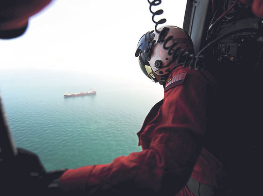 A member of the Malaysian Maritime Enforcement Agency scours the Straits of Malacca in search of survivors. u00e2u20acu201d Picture by Ahmad Zamzahuri