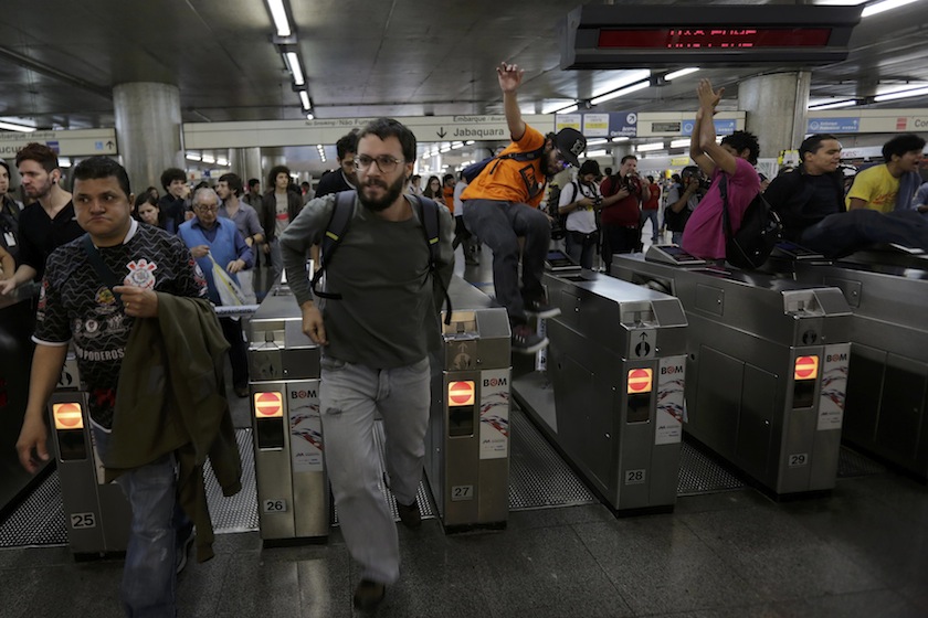 Demonstrators jump over the turnstiles without paying subway fare in support of a strike by metro workers in Sao Paulo June 9, 2014. u00e2u20acu201d Reuters pic