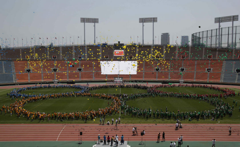 Participants, made up the Olympic symbol, release the Olympic colors of balloons to celebrate and usher in success for the coming Tokyo 2020 Olympic and Paralympic Games during the final event to bid farewell to the National Olympic Stadium in Tokyo May 3