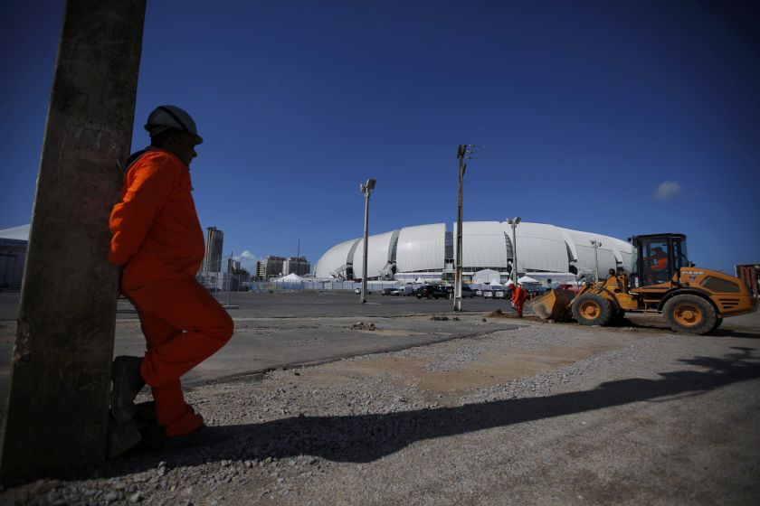 A local worker stands at an unfinished parking area outside of the Dunas arena football stadium in Natal, June 10, 2014. u00e2u20acu2022 Reuters pic