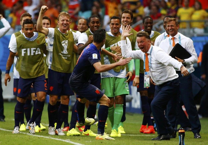 The Netherlandsu00e2u20acu2122 coach Louis van Gaal (right) and Robin van Persie (front) celebrates their goal against Spain during the World Cup Group B match in Salvador June 13, 2014. u00e2u20acu201d Reuters pic