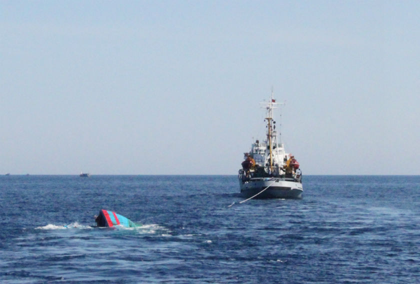 A Vietnamese sinking boat which was rammed and then sunk by Chinese vessels near disputed Paracels Islands, is seen near a Marine Guard ship. u00e2u20acu201d Reuters pic