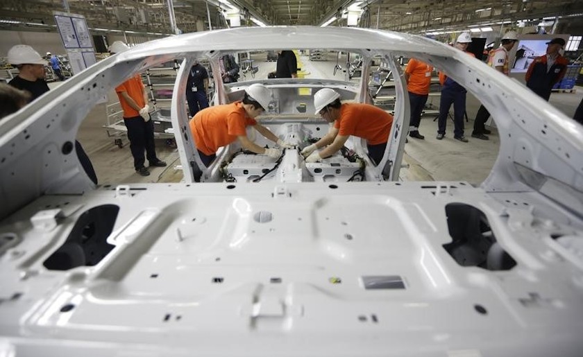 Workers assemble parts of a Volvo car at an assembly line of the new Volvo automobile manufacturing plant in Chengdu, Sichuan province, June 5, 2013. u00e2u20acu201d Reuters pic