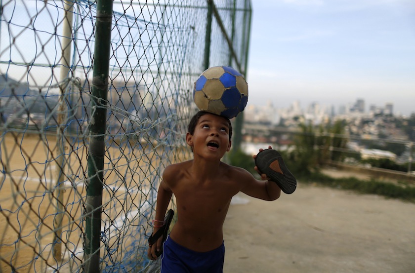 A boy performs with a ball at the Sao Carlos slum in Rio de Janeiro June 7, 2014. u00e2u20acu201du00c2u00a0Reuters pic
