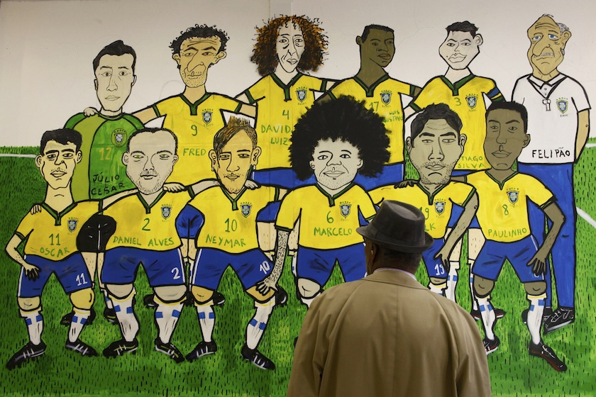 A man looks at a mural of Brazil's national team at a shopping center in Porto Alegre, June 27, 2014. u00e2u20acu201d Reuters pic