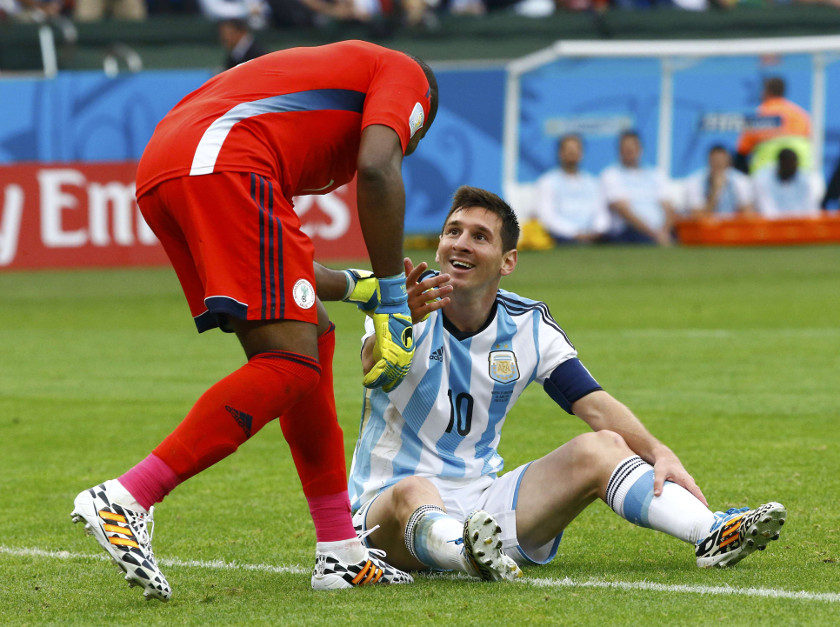 Nigeria's goalkeeper Vincent Enyeama (left) helps Argentina's Lionel Messi up during their 2014 World Cup Group F match at the Beira Rio stadium in Porto Alegre June 25, 2014. u00e2u20acu201d Reuters pic