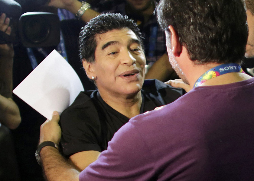 Former Argentine national soccer striker Diego Maradona greets a friend as he enters the studio of a public broadcast company at the International Broadcast Center of the 2014 World Cup in Rio de Janeiro, July 3, 2014. u00e2u20acu201d Reuters pic