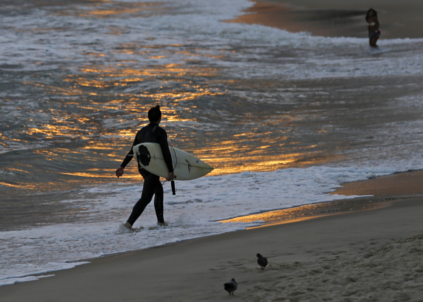 A surfer walks along Ipanema Beach in Rio de Janeiro, with its white beaches, blue ocean and jungle-covered mountains, is still the place that comes to mind when people think of Brazil, July 3, 2014. u00e2u20acu201d Reuters pic