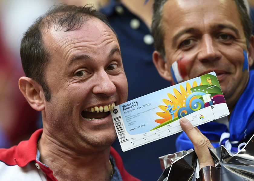 A French fan holds a ticket before the start of the 2014 World Cup round of 16 game against Nigeria at the Brasilia national stadium in Brasilia, July 3, 2014. u00e2u20acu201d Reuters pic