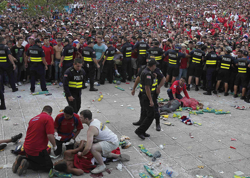 Police officers hold back fans after several men were stabbed while during a final game between Costa Rica and the Netherlands in San Jose, July 7, 2014. u00e2u20acu201d Reuters pic