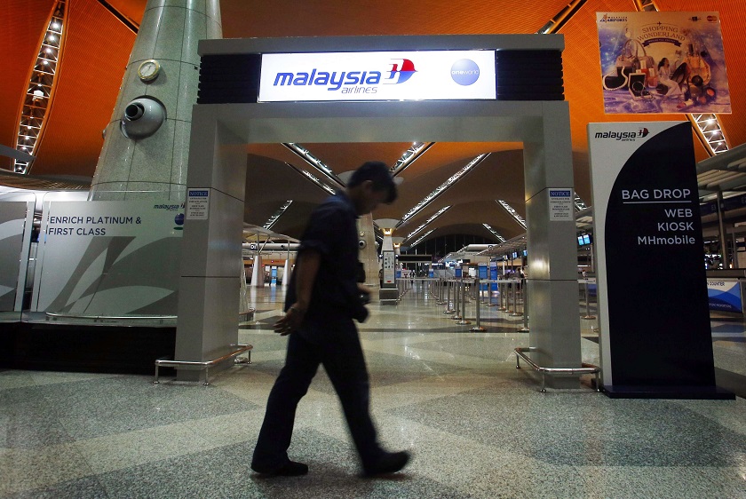 A man walks past the Malaysia Airlines check-in area at Kuala Lumpur International Airport in Sepang July 18, 2014. u00e2u20acu201d Reuters pic