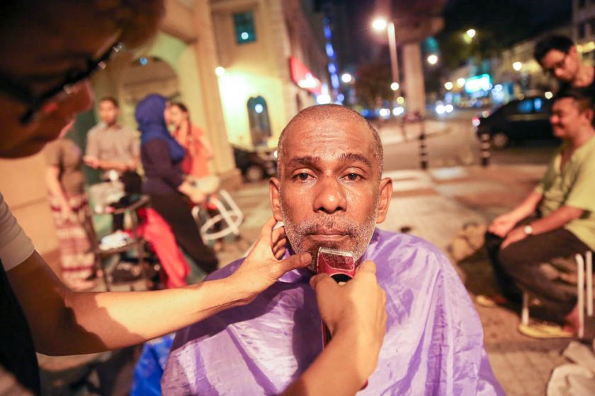Kandasamy Muthuraman getting a free haircut at the Pertiwi soup kitchen, June 23, 2014. — Picture by Choo Choy May