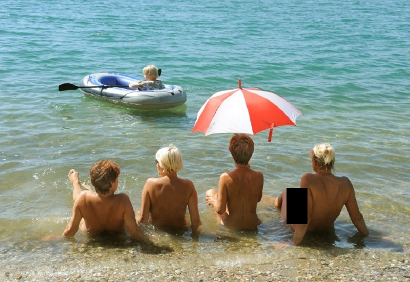 A picture taken on August 19, 2012 shows four nude women under a sun shade and sunbathing at lake Grillensee in Naunhof near Leipzig, eastern Germany.  u00e2u20acu201d AFP pic