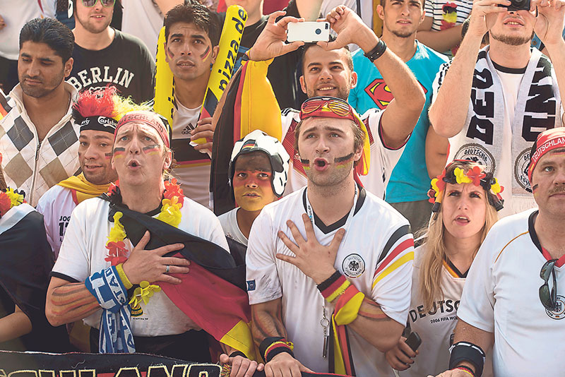 German football fans sing their national anthem at the ‘Fan Mile’, where the 2014 World Cup Group G match between Germany and Portugal is screened, in Berlin, June 16, 2014. — Picture by Reuters