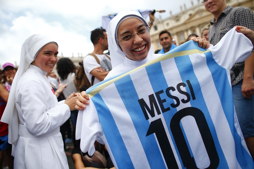A nun holding a soccer jersey with the number of Argentine national player Lionel Messi, smiles as she waits for Pope Francis' Sunday Angelus prayer in Saint Peter's square at the Vatican July 13, 2014. u00e2u20acu201d Reuters pic