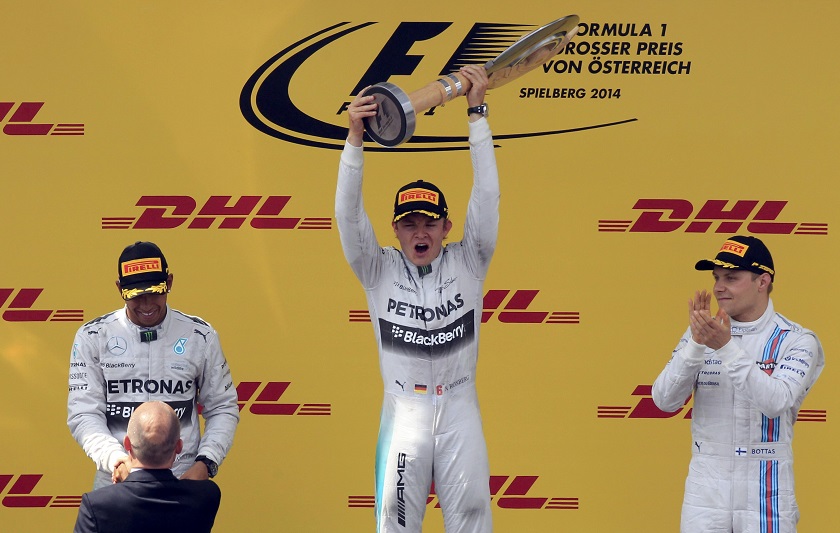Winner Mercedes Formula One driver Nico Rosberg of Germany celebraates on the podium between second placed team mate Mercedes Formula One driver Lewis Hamilton of Britain (left) and third placed Williams Formula One driver Valtteri Bottas of Finland (righ