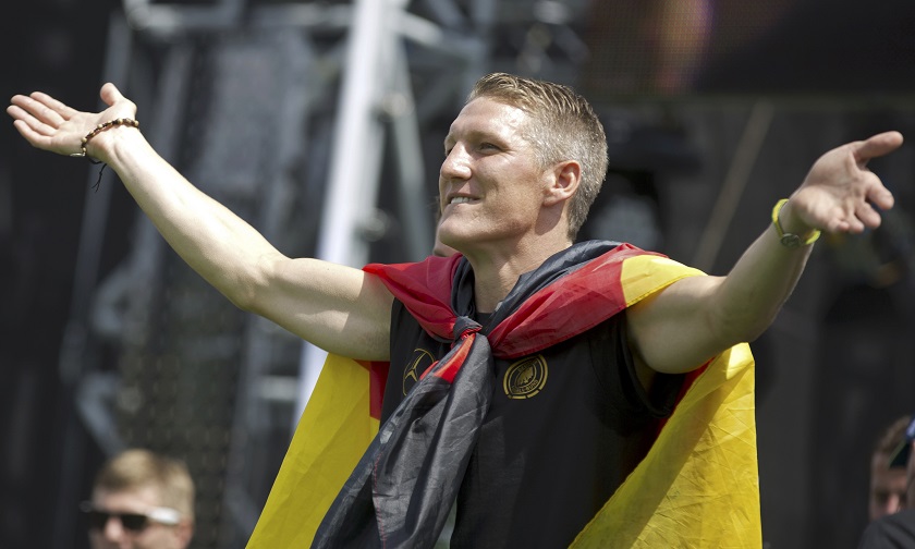 German football player Bastian Schweinsteiger gestures to fans on a stage during celebrations to mark the team's 2014 Brazil World Cup victory, at a 'fan mile' public viewing zone in Berlin July 15, 2014. u00e2u20acu201d Reuters pic