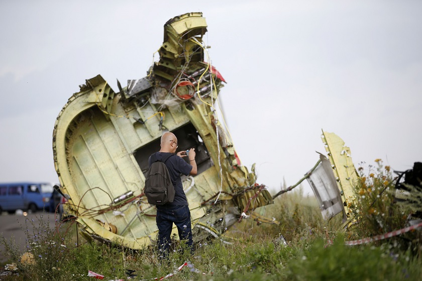 A Malaysian air crash investigator inspects the crash site of Malaysia Airlines Flight MH17, near the village of Hrabove (Grabovo), Donetsk region July 22, 2014. u00e2u20acu201d Reuters pic