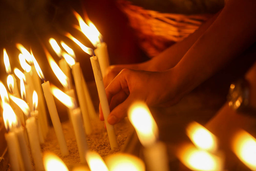 A member of the public lights candles during a candlelight vigil for the victims on board MAS flight MH17 in Bangsar, on July 24, 2014. u00e2u20acu201d Picture by Choo Choy May