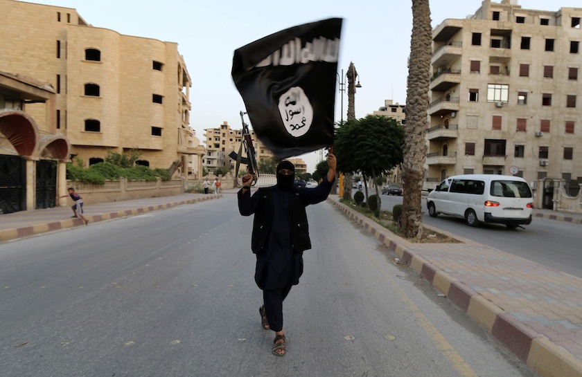 A member loyal to the Islamic State in Iraq and the Levant (ISIL) waves an ISIL flag in Raqqa June 29, 2014. u00e2u20acu201du00c2u00a0Reuters pic