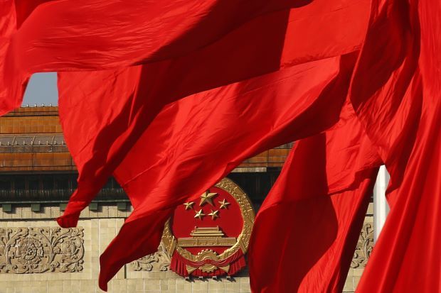 The Great Hall of the People, seen behind red flags in Tiananmen square in Beijing November 12, 2013. Reuters