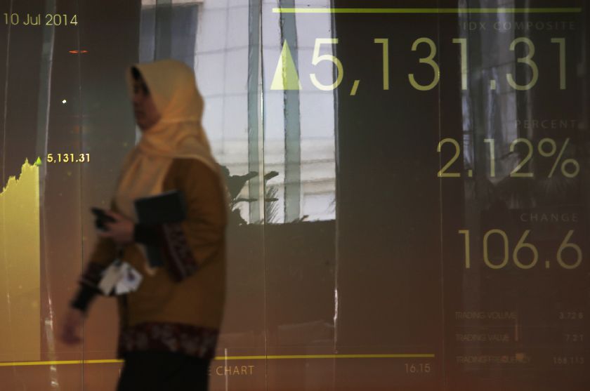 A woman walks in front of the Indonesia Stock Exchange screen in Jakarta, July 10, 2014. Rose more than 2 per cent to a one-year high on expectations Joko ,Jokowi, Widodo will be the next president Reuters