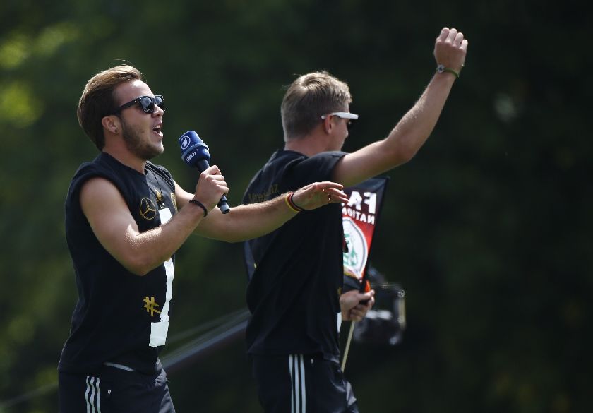 Match winner Mario Goetze (left) and Toni Kroos applaud fans at the ‘fan mile’ public viewing zone in Berlin.