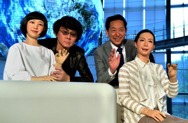 Former astronaut and director of the National Museum of Emerging Science and Technology in Tokyo, Mamoru Mori (R), and Osaka University professor Hiroshi Ishiguro (L) with female humanoid robots ,Otonaroid, (R) and ,Kodomoroid, (L) June 24, 2014 AFP