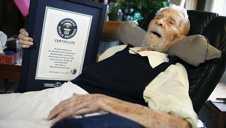 111-year-old Alexander Imich holds a Guinness World Records certificate recognising him as the world's oldest living man during an interview with Reuters at his home on New York City's upper west side on May 9, 2014 Reuters