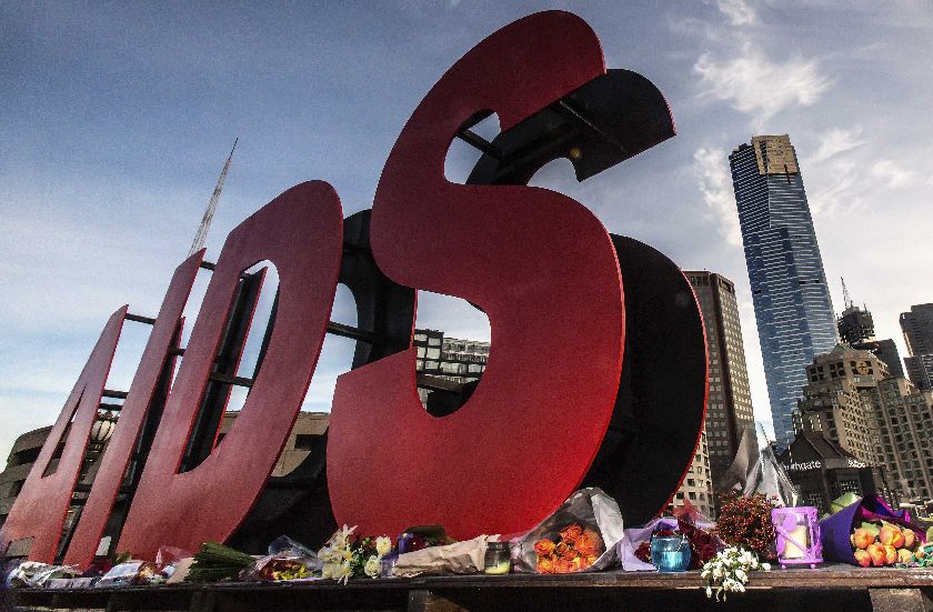 Flowers laid in tribute to those killed in the Malaysia Airlines flight MH17, at the base of a sign for the 20th International AIDS Conference in Melbourne July 20, 2014 Reuters