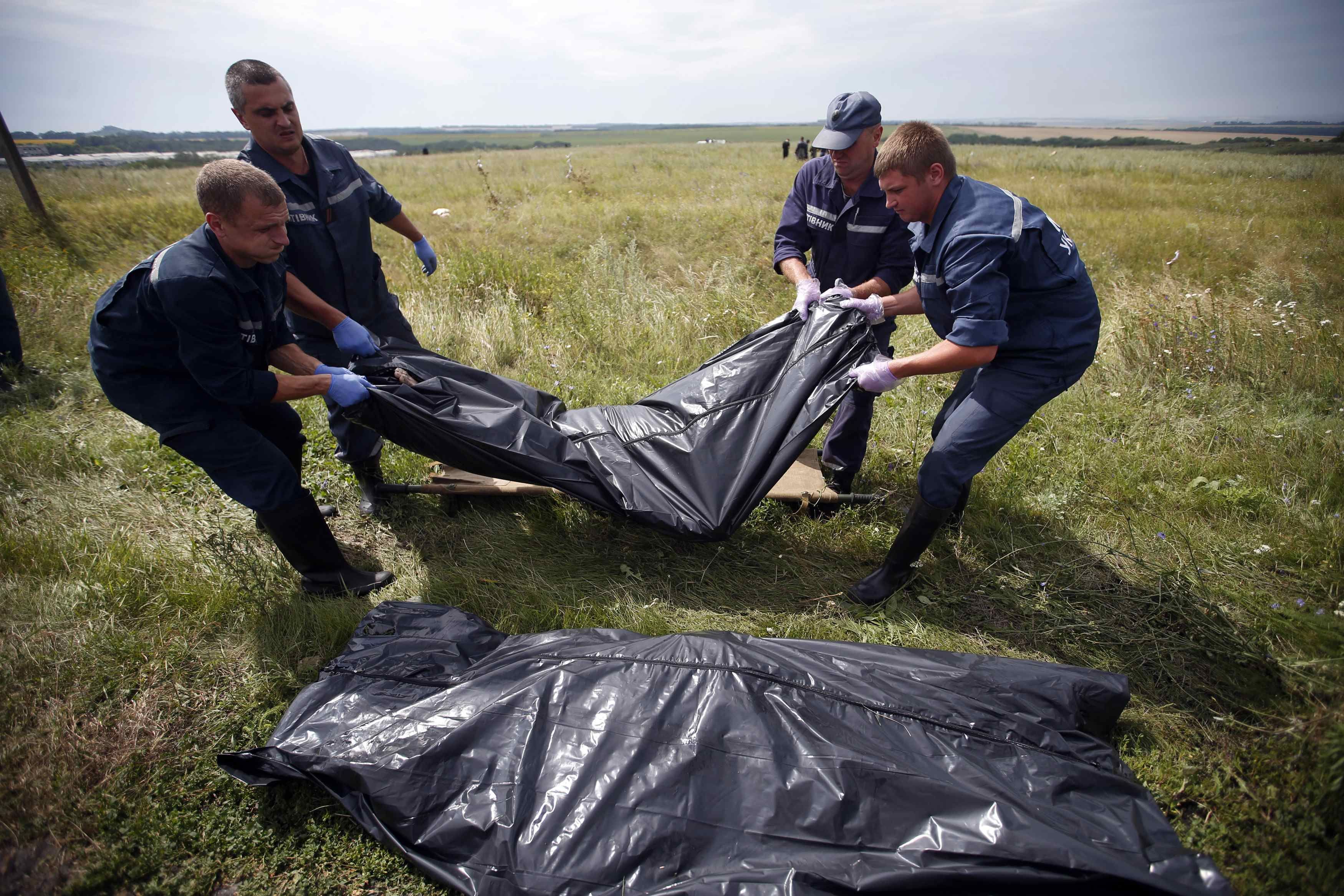 Members of the Ukrainian Emergency Ministry carry a body at the crash site of Malaysia Airlines Flight MH17, near the settlement of Grabovo in the Donetsk region July 20, 2014. u00e2u20acu2022 Reuters pic