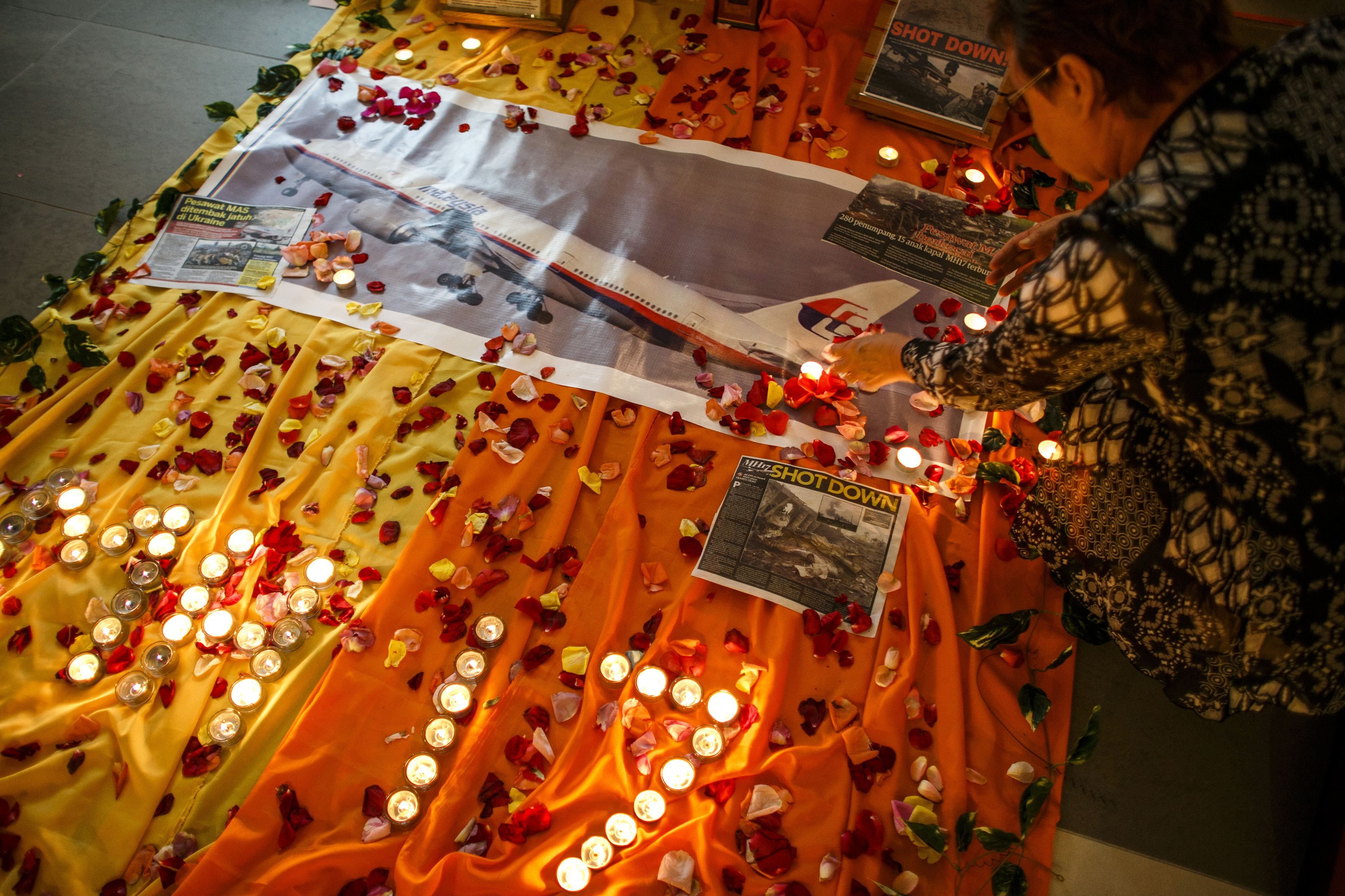 A woman lights candles at a memorial for victims of the downed Malaysia Airlines Flight MH17 in Kuala Lumpur July 18, 2014. u00e2u20acu201d Reuters pic