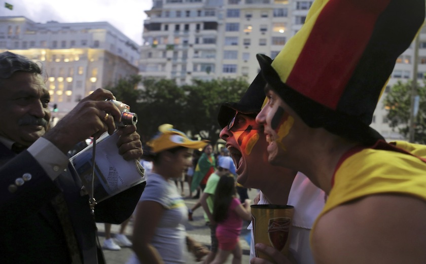 Germany fans grimace as they are photographed by a man on Copacabana beach ahead of the World Cup final match between Argentina and Germany, in Rio de Janeiro July 13, 2014.u00c2u00a0u00e2u20acu201d Reuters pic