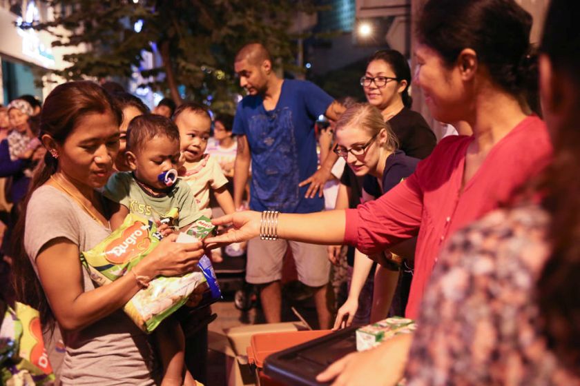 Volunteers from Need to Feed the Need soup kitchen handing out food to the homeless and urban poor at Jalan Tuanku Abdul Rahman. u00e2u20acu201d Picture by Choo Choy May