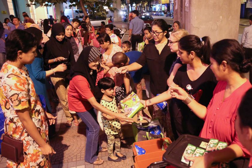 Volunteers from Need to Feed the Need soup kitchen handing out food to the homeless and urban poor at Jalan Tuanku Abdul Rahman. u00e2u20acu201d Picture by Choo Choy May