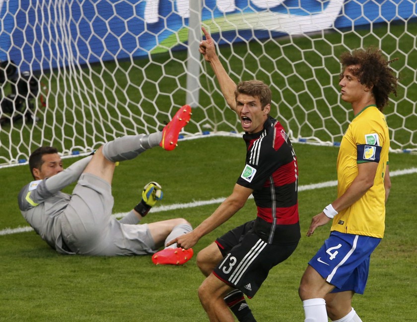 Germanyu00e2u20acu2122s Thomas Mueller (centre) celebrates past Brazilu00e2u20acu2122s David Luiz and goalkeeper Julio Cesar after scoring a goal during their World Cup semi-finals in Belo Horizonte July 8, 2014. u00e2u20acu201d Reuters pic