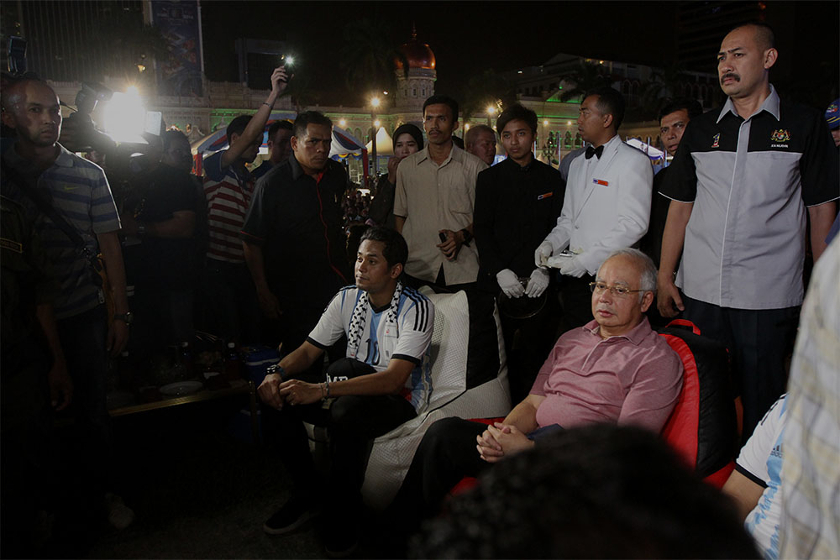 Prime Minister Datuk Seri Najib Razak (right, seated) and Minister of Youth and Sports Khairy Jamaluddin watch the broadcast of the 2014 World Cup final at Dataran Merdeka, Kuala Lumpur, on July 14, 2014. u00e2u20acu201d Picture by Yusof Mat Isa