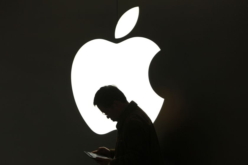 A man looks at his Apple iPad in front an Apple logo outside an Apple store in downtown Shanghai in this file photo from March 16, 2012. u00e2u20acu201d Reuters pic