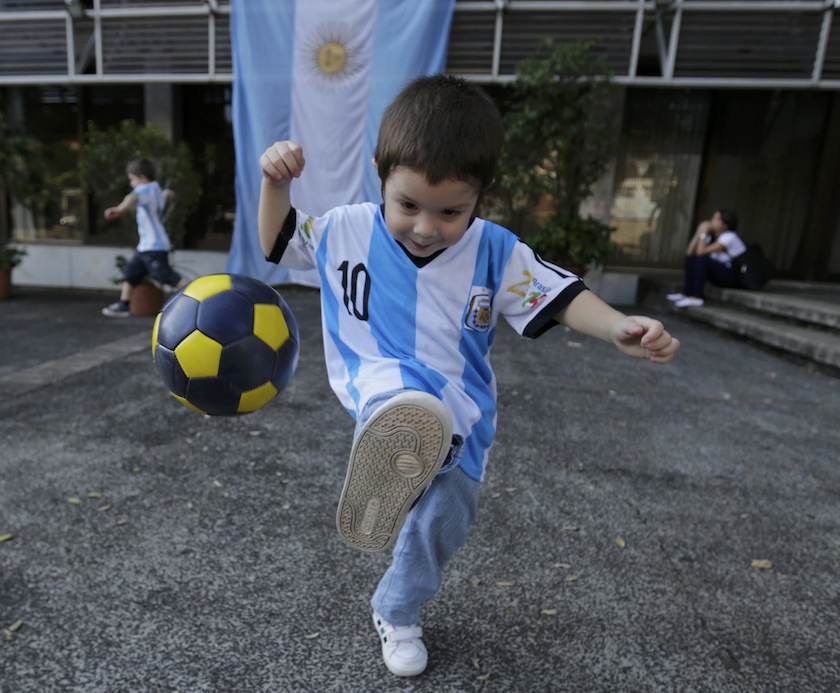 A child wearing an Argentina jersey plays with a ball as the 2014 World Cup Final in Rio de Janeiro between Argentina and Germany was being played, in Asuncion July 14, 2014.u00c2u00a0u00e2u20acu201d Reuters pic