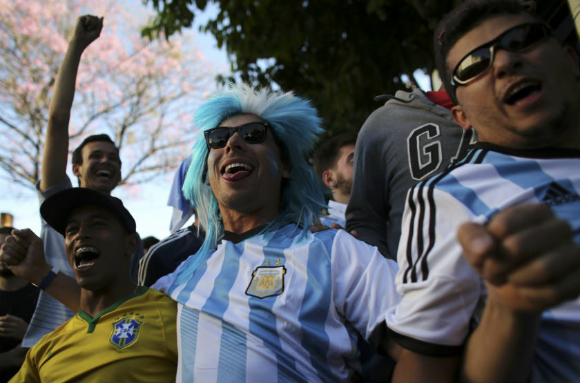 Argentina soccer fans celebrate goal with a Brazilian fan at Vila Madalena neighbourhood during the 2014 World Cup round of 16 soccer match between Argentina and Switzerland in Sao Paulo. u00e2u20acu201d Reuters pic