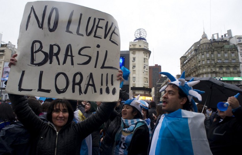 File picture shows Argentina fans celebrating next to the Obelisco in Buenos Aires on July 5, 2014 after Argentina defeated Belgium and qualified for 2014 World Cup semi-finals. Sign reads u00e2u20acu02dcItu00e2u20acu2122s not raining, Brazil is cryingu00e2u20acu2122. u00e2u20acu201d AFP pic