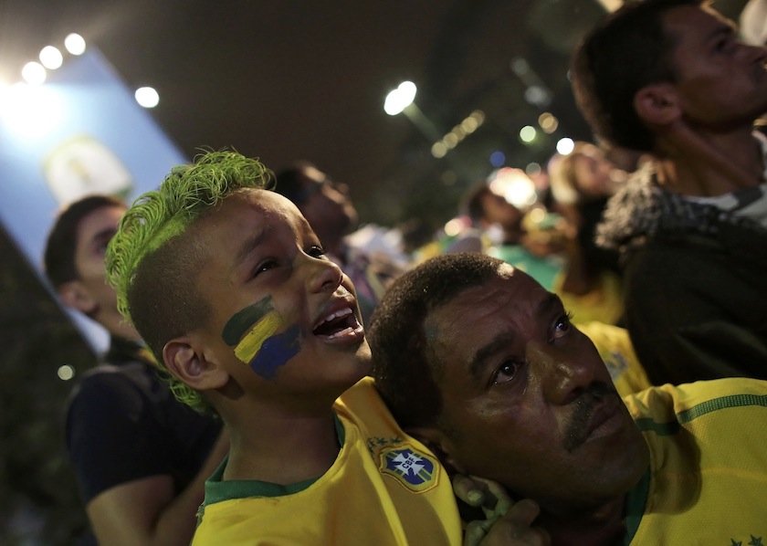 A Brazilian boy fan cries next to his father as they watch a broadcast of the 2014 World Cup semi- final match between Brazil and Germany in Sao Paulo, July 9, 2014.u00c2u00a0u00e2u20acu201d Reuters pic