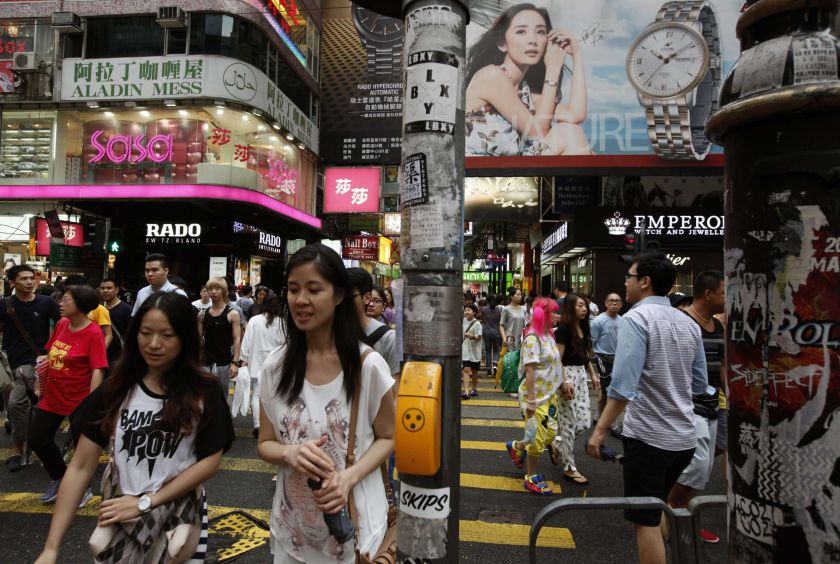 Shoppers cross a street at Hong Kongu00e2u20acu2122s Causeway Bay shopping district that is at risk of losing its crown as the worldu00e2u20acu2122s most expensive retail space as a slowdown in mainland tourists hits store sales, in picture released July 24, 2012. u00e2u20acu201d Reuters  p