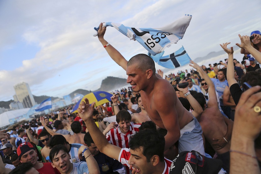 An Argentine fan waves a Lionel Messi jersey on Copacabana beach ahead of tomorrow's World Cup final match between Argentina and Germany in Rio de Janeiro July 12, 2014.u00c2u00a0u00e2u20acu201du00c2u00a0Reuters pic