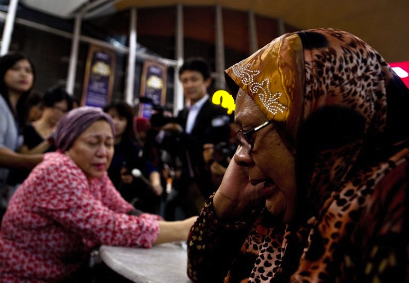 Relatives of people onboard Malaysia Airlines flight MH17 from Amsterdam react outside the family holding area at the Kuala Lumpur International Airport in Sepang on July 18, 2014. u00e2u20acu201d AFP pic