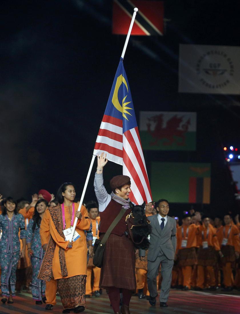 Fatehah Mustapa carries the Malaysian flag at half staff during the opening ceremony for the 2014 Commonwealth Games at Celtic Park in Glasgow July 23, 2014. u00e2u20acu201d Reuters pic