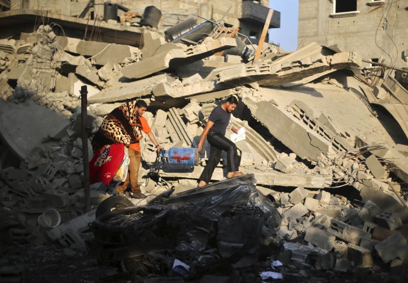 Palestinians carry their belongings from a house which police said was destroyed in an Israeli air strike in the northern Gaza Strip July 10, 2014. u00e2u20acu2022 Reuters pic