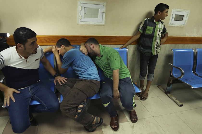 Palestinians react after their relatives were killed in what hospital officials said was an Israeli air strike in Gaza City July 12, 2014. u00e2u20acu201du00c2u00a0Reuters pic