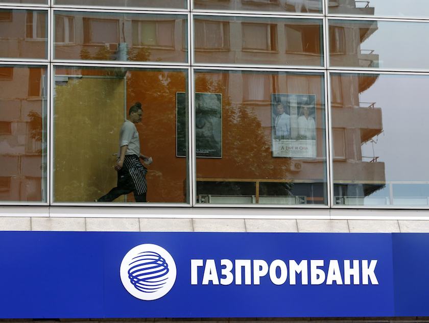 A person is pictured through a window above a Gazprombank branch in Moscow July 17, 2014. u00e2u20acu201d Reuters pic