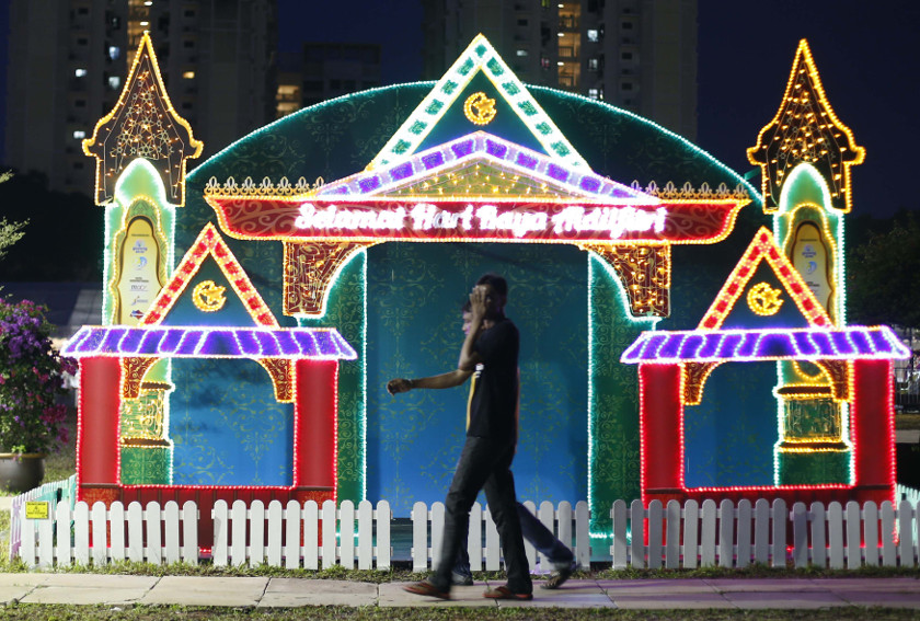 People pass a festive decoration at a Hari Raya bazaar, on the eve of Eid al-Fitr, in Singapore July 27, 2014. u00e2u20acu201d Reuters pic